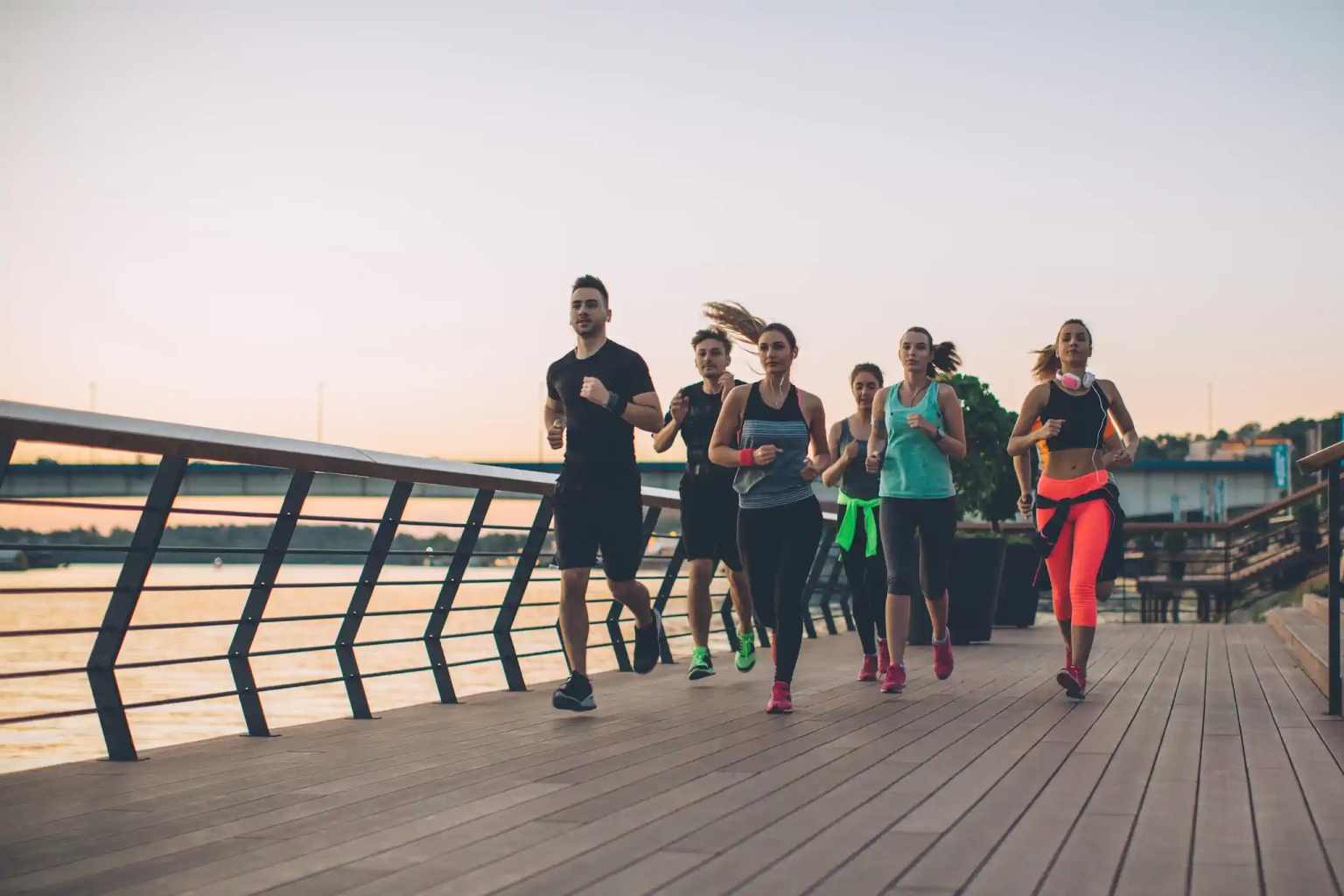 People on a pier running with a trainer